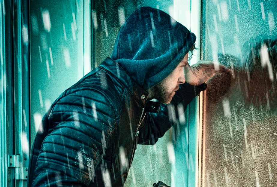 burglar looking into window with security film for windows Toronto