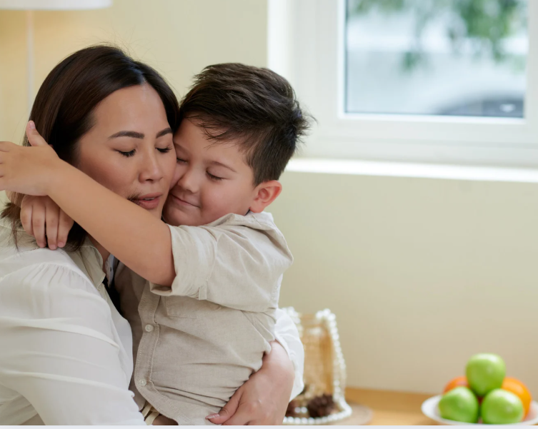 Asian mom hugs son knowing safety window protection GTA gives her peace of mind