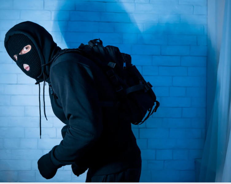 burglar sneaking away because window safety film installation toronto